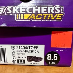 Sketchers with straps that cross on top.